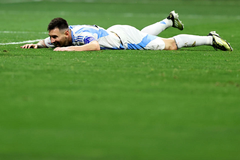 ATLANTA, GEORGIA - JUNE 20: Lionel Messi of Argentina lies at the pitch during the CONMEBOL Copa America group A match between Argentina and Canada at Mercedes-Benz Stadium on June 20, 2024 in Atlanta, Georgia. (Photo by Omar Vega/Getty Images)