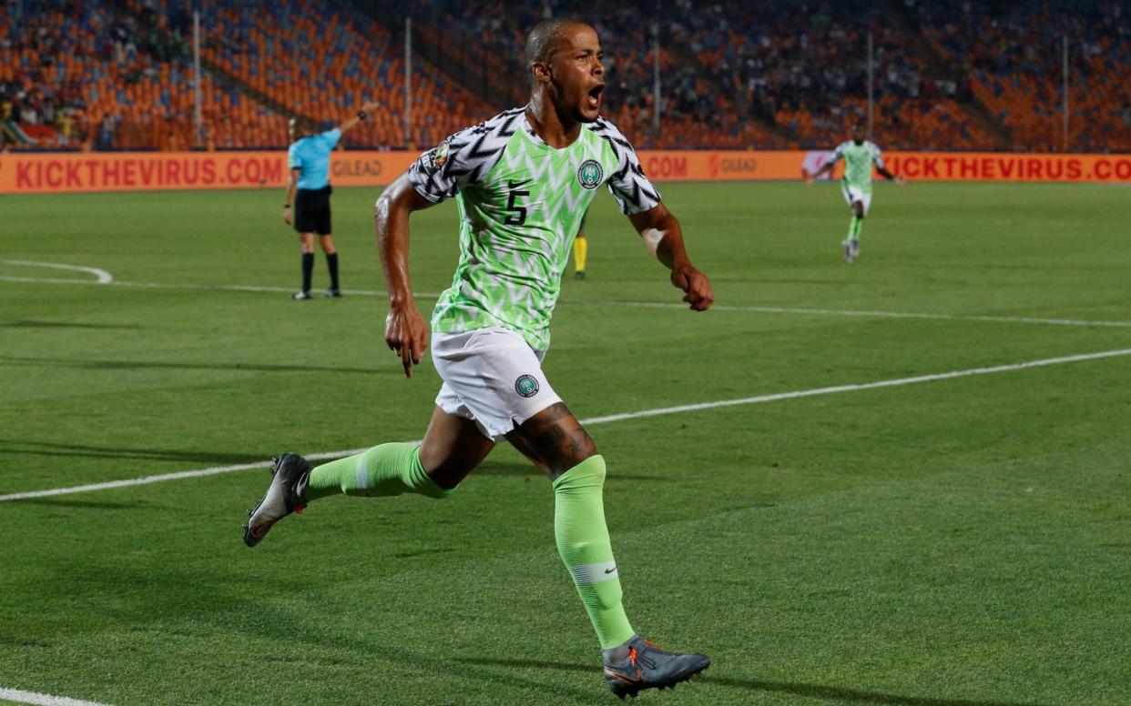 Nigeria's William Troost-Ekong celebrates the winning goal - in the background, a message to 'kick the virus' is broadcast to the world - REUTERS
