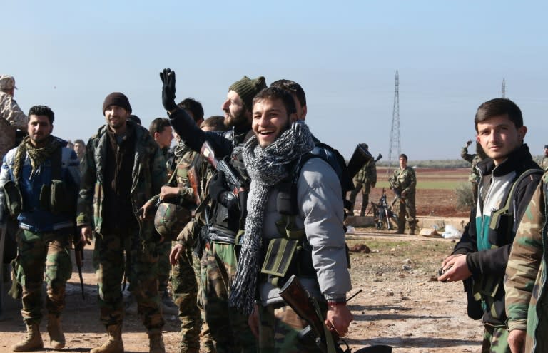 Syrian pro-government forces celebrate after they broke an opposition siege in the northern Shiite town of Zahraa