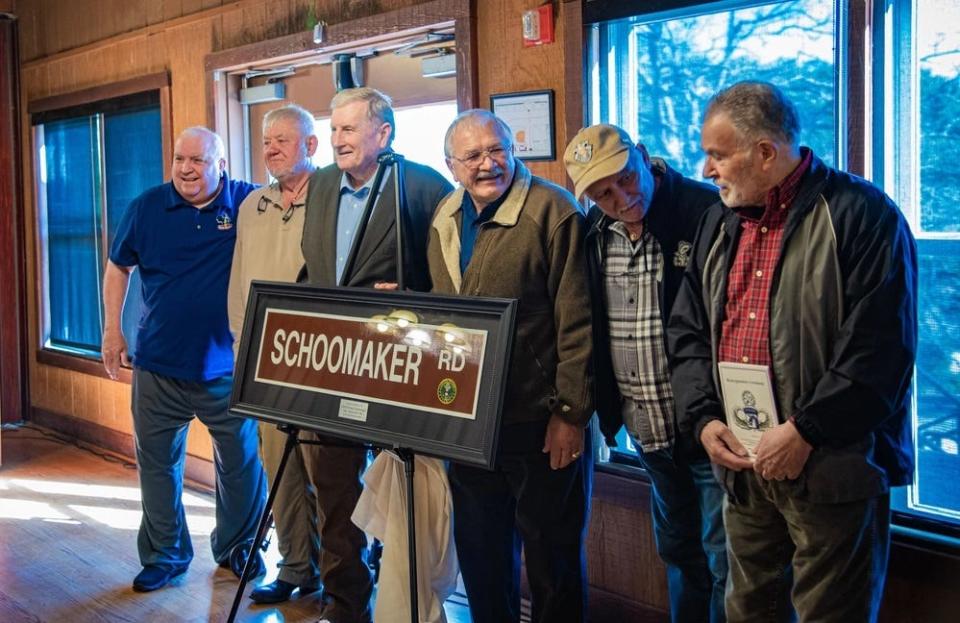 Retired Gen. Peter Schoomaker, third from left, poses with friends and fellow veterans following the Dec. 15, 2023, ceremony to rename McKellars Road to Schoomaker Road on Fort Liberty.