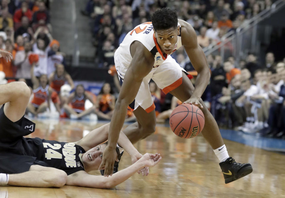 FILE - In this March 30, 2019, file photo, Virginia's De'Andre Hunter dribbles past Purdue's Grady Eifert (24) during the first half of a men's NCAA Tournament college basketball South Regional final game, in Louisville, Ky. Hunter is a high prospect in the NBA Draft on Thursday, June 20. (AP Photo/Michael Conroy, File)