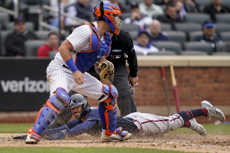 Atlanta Braves' Dansby Swanson scores on an RBI single hit by Ronald Acuna Jr. off New York Mets relief pitcher Trevor Williams in the sixth inning of a baseball game, Wednesday, May 4, 2022, in New York. (AP Photo/John Minchillo)