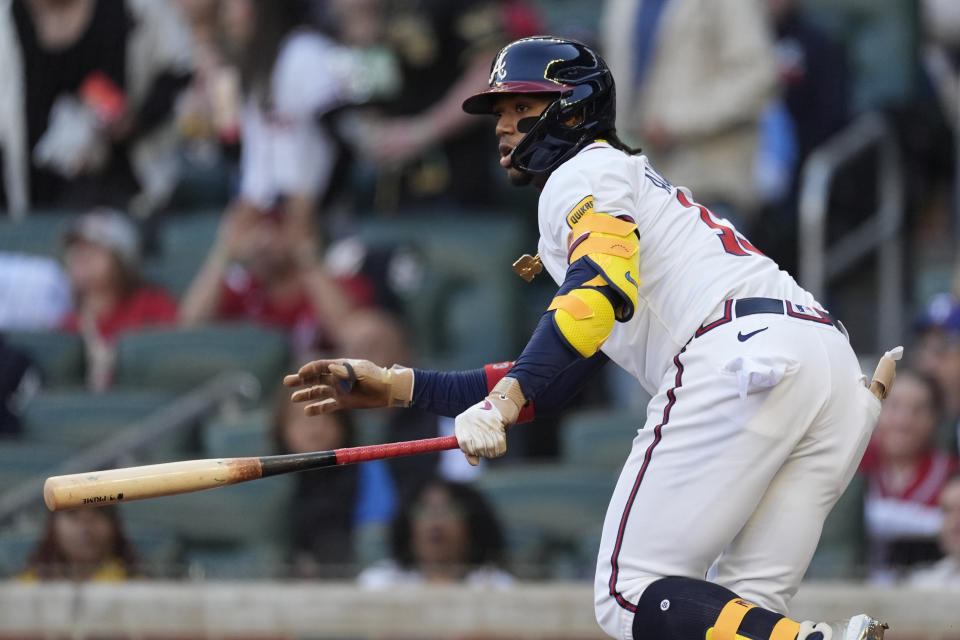 Atlanta Braves' Ronald Acuña Jr. hits a single in the first inning of a baseball game against the Texas Rangers Sunday, April 21, 2024, in Atlanta. (AP Photo/John Bazemore)