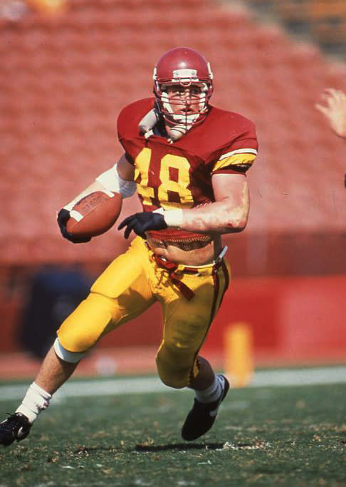 In a photo provided by USC Athletics, former Southern California player Matthew Gee plays in an NCAA college football game. A lawsuit alleging that the NCAA failed to protect a former Gee from repeated concussions is nearing trial in a Los Angeles court, with a jury seated Thursday, Oct. 20, 2022, in what could become a landmark case. The suit filed by Gee's widow says the former USC linebacker died in 2018 from permanent brain damage caused by countless blows to the head he took while playing for the 1990 Rose Bowl-winning team. (USC Athletics via AP)