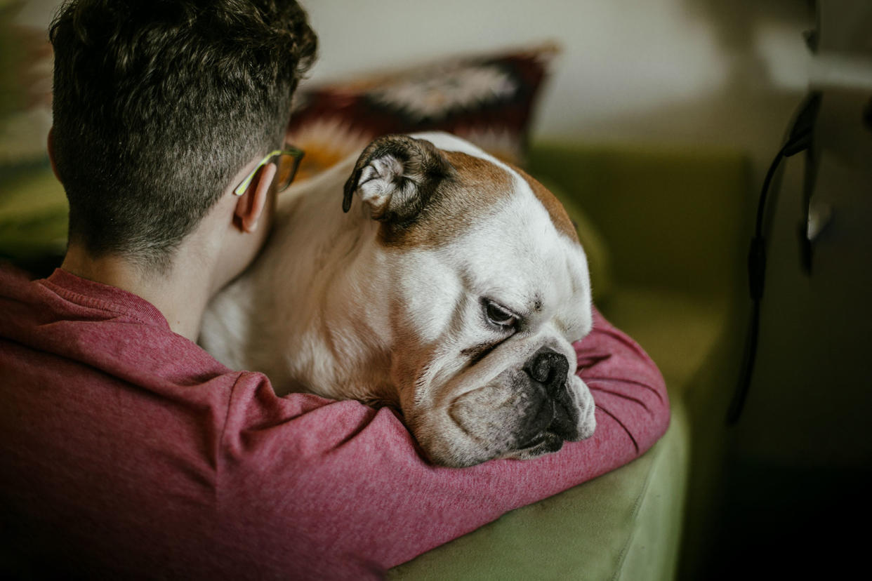 Man hugging dogGetty Images/Carol Yepes