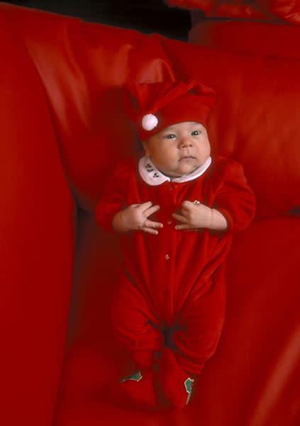 <b>Top 10 cute baby Christmas outfits </b><br><br>This baby looks a little perplexed in his mini Santa costume complete with hat and holly feet.<br><br>© Rex