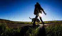 <p>A woman walks her dog in bright sunshine on a country lane near Fellbach, Germany, Aug. 24, 2016. The good weather will continue in Baden-Wuerttemberg for the next days. (Photo: CHRISTOPH SCHMIDT/EPA) </p>