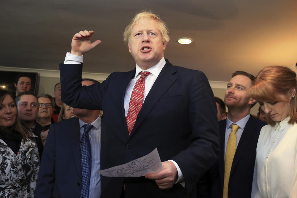 Britain's Prime Minister Boris Johnson gestures as he speaks to supporters during a visit to meet newly elected Conservative party lawmakers at Sedgefield Cricket Club in County Durham, north east England on Saturday Dec. 14, 2019, following his Conservative party's general election victory.  Johnson called on Britons to put years of bitter divisions over the country's EU membership behind them as he vowed to use his resounding election victory to finally deliver Brexit. (Lindsey Parnaby / Pool via AP)