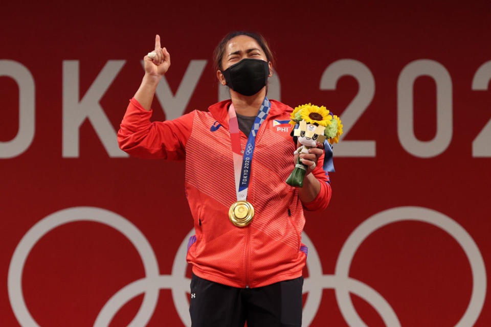 Gold medalist Hidilyn Diaz of Team Philippines poses with the gold medal during the medal ceremony for the Weightlifting - Women's 55kg Group A on day three of the Tokyo 2020 Olympic Games at Tokyo International Forum on July 26, 2021 in Tokyo, Japan.<span class="copyright">Chris Graythen—Getty Images</span>