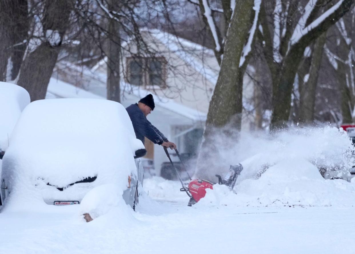 Snow is removed from a driveway along West Euclid Avenue in Milwaukee on Sunday, Jan. 29, 2023. Several area of Southeast Wisconsin saw several inches of snow that fell overnight Saturday into Sunday.