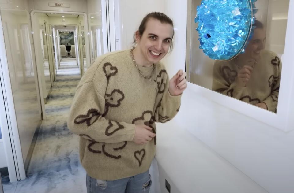 Chris smiling while standing in a hallway