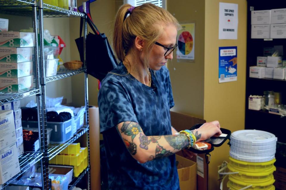 Emily Wadden, a program manager with the Safe Works Access Program in St. John's, shows reporters the contents of a naloxone kit.