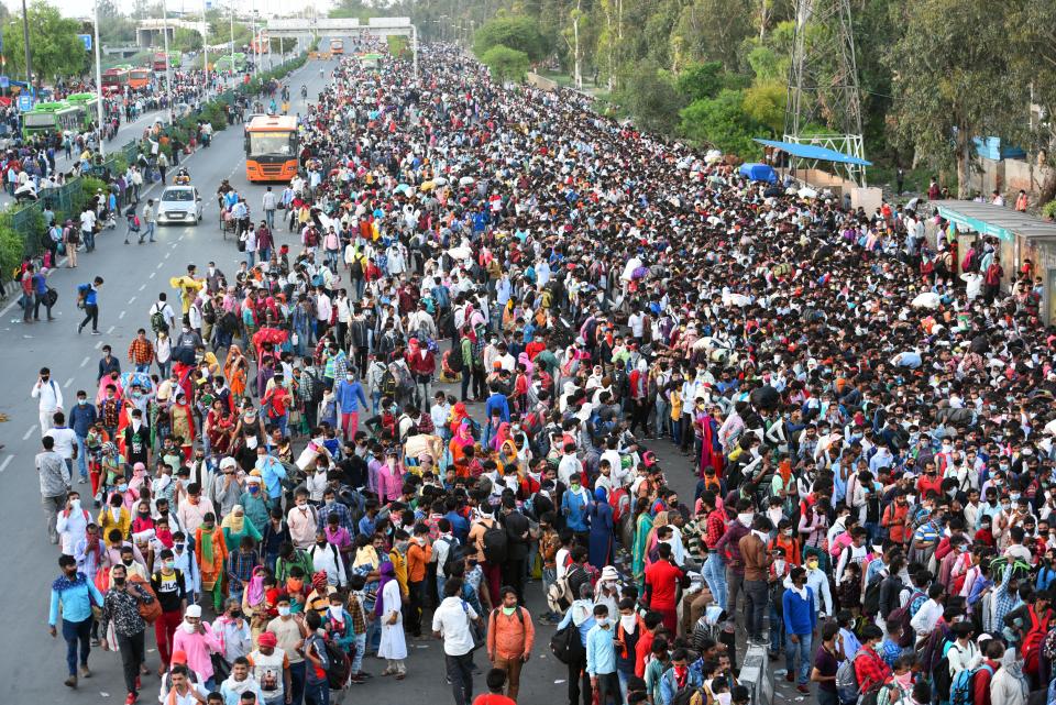 NEW DELHI, INDIA - MARCH 28: A wave of migrant workers seen at Anand Vihar Bus Terminus near the Delhi - UP border following Uttar Pradesh governments call to arrange buses for the workers returning to their native state, on Day 4 of the 21 day nationwide lockdown -- to check the spread of coronavirus, on March 28, 2020 in New Delhi, India. (Photo by Raj K Raj/Hindustan Times via Getty Images)