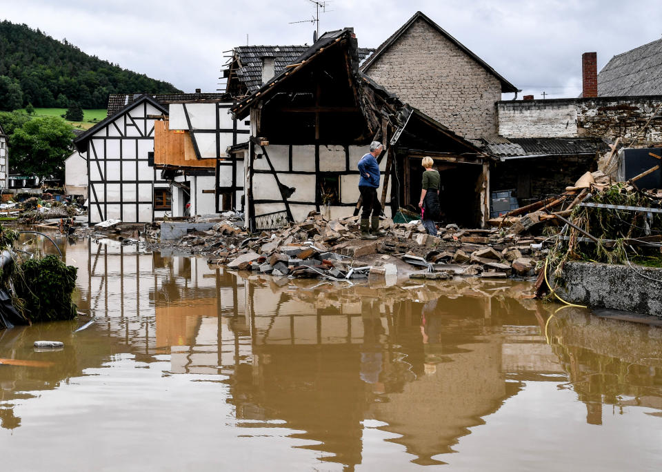 Residents inspect a collapsed house after the flooding of the river Ahr, in Schuld, Germany, on Thursday.