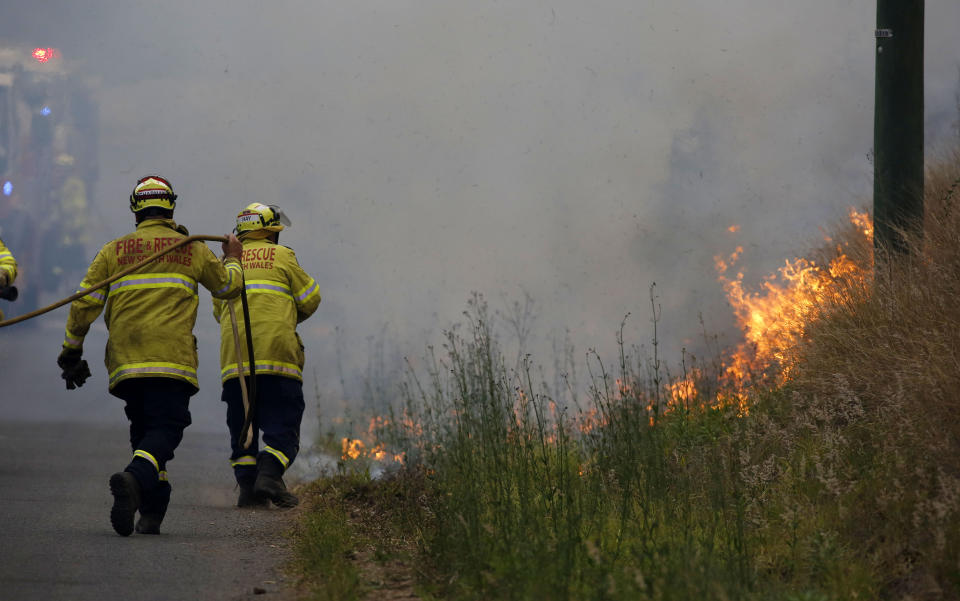 Firefighters work on a controlled burn in Koorainghat, south of Taree.