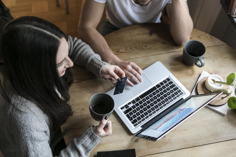 A photo of a man and a woman shopping online.