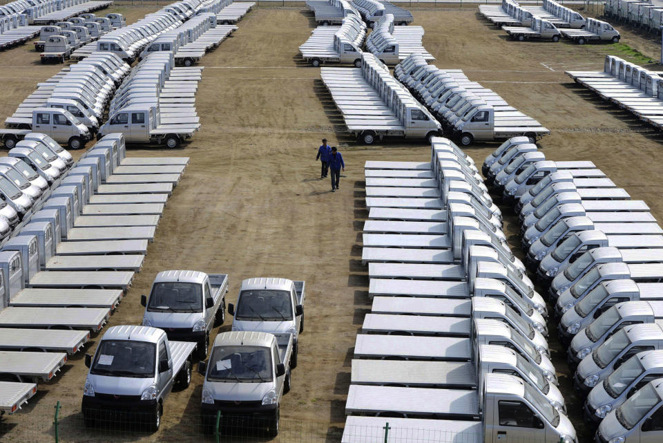 In this photo taken Wednesday April 16, 2014, vehicles are parked outside a factory of SGMW, a joint venture between Chinese carmakers and General Motors in Qingdao in east China's Shandong province. China’s automakers are the underdogs heading into next week’s Beijing auto show, where foreign and domestic brands will jostle for attention in a crowded market. Facing intense competition from General Motors, Volkswagen and other global rivals, local brands such as Chery, Geely and SUV maker Great Wall have seen sales and market share shrink this year while China’s overall market grew. (AP Photo) CHINA OUT