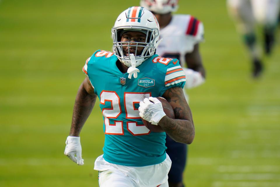 Miami Dolphins cornerback Xavien Howard (25) runs the football during the first half of an NFL football game against the New England Patriots, Sunday, Dec. 20, 2020, in Miami Gardens, Fla.