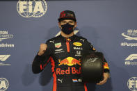 Red Bull driver Max Verstappen of the Netherlands celebrates after he won the pole position at the Formula One Abu Dhabi Grand Prix in Abu Dhabi, United Arab Emirates, Saturday, Dec. 11, 2020. (AP Photo/Kamran Jebreili, Pool)