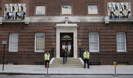 Police officers stand outside the entrance to the Lindo wing of St Mary's Hospital in central London, May 2, 2015. REUTERS/Suzanne Plunkett