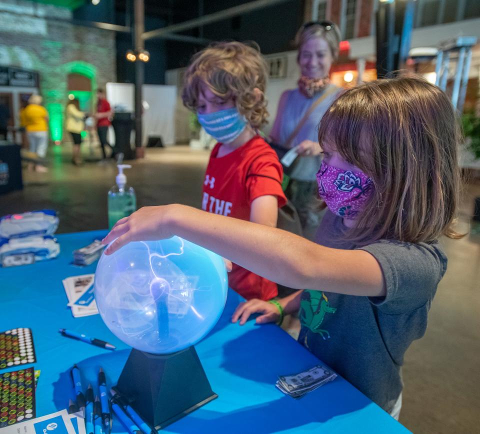 Lorelei Pilger, 8, right, and Marshall Pilger, 9, check out a booth at Autism Pensacola’s Sensory Street event at the Museum of Commerce in downtown Pensacola on Thursday, June 24, 2021. The second annual Autism Pensacola Sensory Street is being held on June 24-25, 2022 from 9 a.m. to 2 p.m. at the Historic Pensacola Museum of Commerce on 201 E. Zaragoza St.