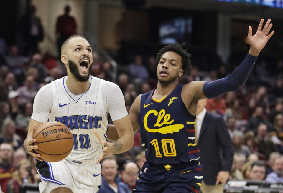Orlando Magic's Evan Fournier, left, drives past Cleveland Cavaliers' Darius Garland in the first half of an NBA basketball game, Friday, Dec. 6, 2019, in Cleveland. (AP Photo/Tony Dejak)