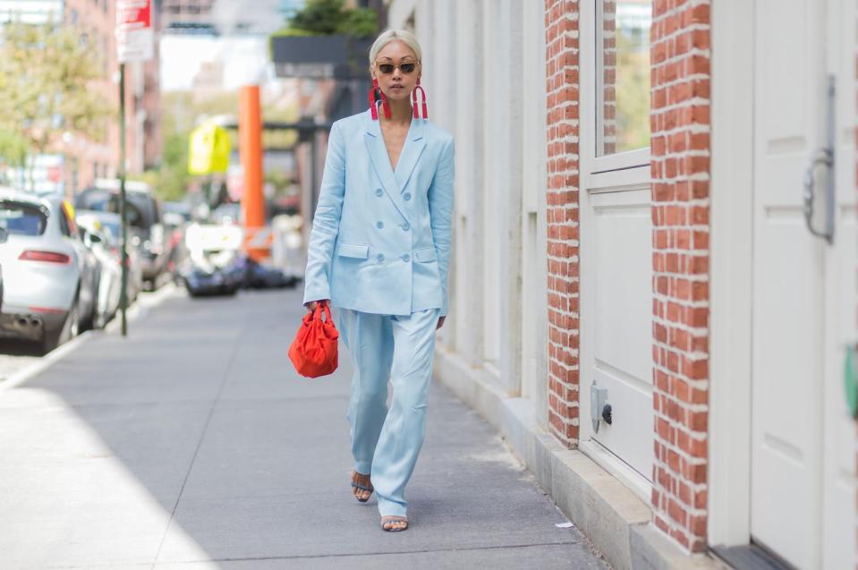 <p>A well-tailored suit in an unexpected hue like powder blue will feel festive—but not kitschy. (Let the contrasting red handbag take that role instead.)</p>