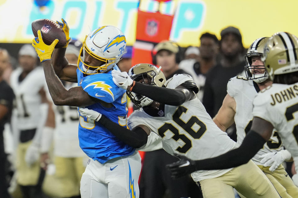 Los Angeles Chargers wide receiver Terrell Bynum (35) pulls in a pass on a fourth-and-23 against New Orleans Saints cornerback Anthony Johnson (36) in the second half of an NFL football game in Inglewood, Calif., Sunday, Aug. 20, 2023. (AP Photo/Marcio Jose Sanchez)
