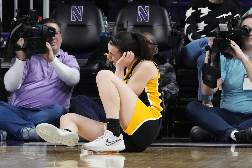 Iowa guard Caitlin Clark reacts after falling down on the court during the second half of an NCAA college basketball game against Northwestern in Evanston, Ill., Wednesday, Jan. 31, 2024. Iowa won 110-74. (AP Photo/Nam Y. Huh)