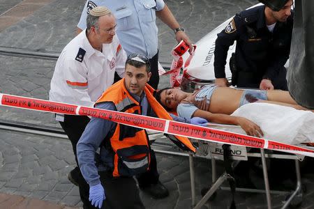 Israeli medics evacuate a wounded Palestinian minor, who police said stabbed an Israeli security guard, in Pisgat Zeev, which lies on occupied land that Israel annexed to Jerusalem after the 1967 Middle East war, November 10, 2015. REUTERS/Ammar Awad