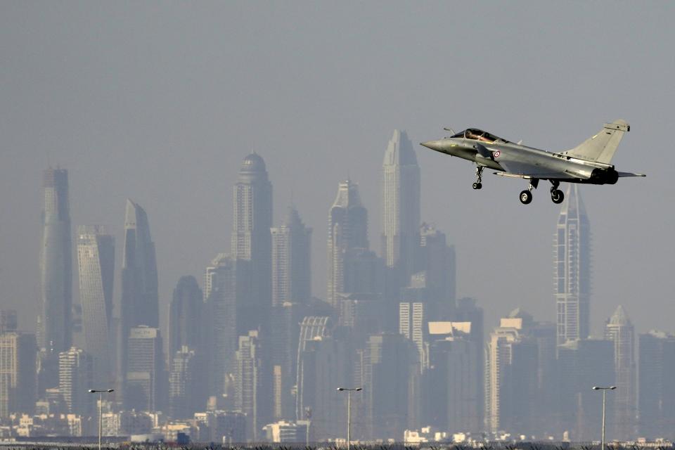 The skyline of the city is seen on the background as a French Air Force Dassault Rafale C jet fighter prepares to land during the opening day of the Dubai Air Show, United Arab Emirates, Monday, Nov. 13, 2023. (AP Photo/Kamran Jebreili)