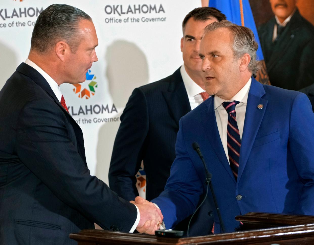 Speaker Charles McCall, left, welcomes President Pro Tem Greg Treat to the podium as Gov. Stitt looks on. Governor Kevin Stitt, President Pro Tem Greg Treat, and Speaker Charles McCall, along with other members from the House and Senate, will hold a joint press conference to announce their historic education reform agreement in the Blue Room of the Oklahoma State Capitol Monday, May 15, 2023.