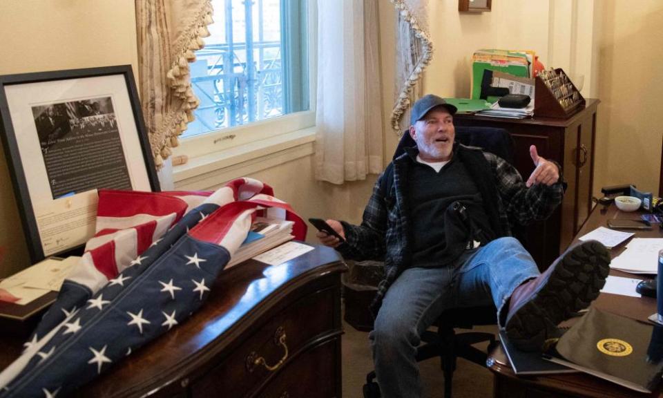 White nationalist Richard Barnett, with his infamous boots on Nancy Pelosi’s desk.