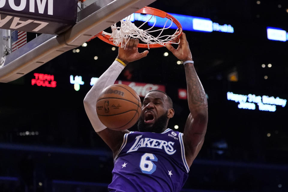 Los Angeles Lakers forward LeBron James (6) dunks the ball during the first half of an NBA basketball game against the Atlanta Hawks in Los Angeles, Friday, Jan. 7, 2022. (AP Photo/Ashley Landis)