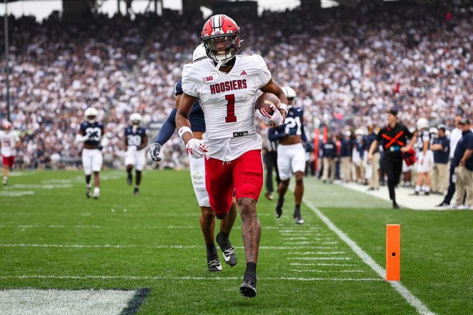 Donaven McCulley #1 of the Indiana Hoosiers scores a touchdown against the Penn State Nittany Lions during the first half at Beaver Stadium on October 28, 2023 in State College, Pennsylvania.