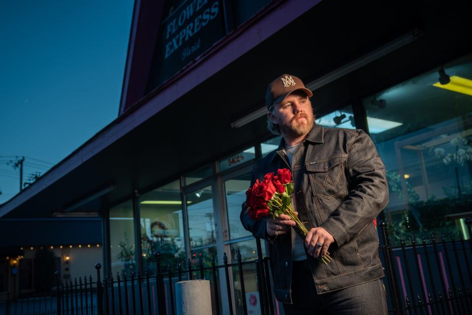 Country music artist Ernest Keith Smith, known as Ernest, poses at Flower Express in Nashville, Tenn., Monday, Jan. 23, 2023. Ernest has an upcoming deluxe album titled “Two Dozen Roses.”