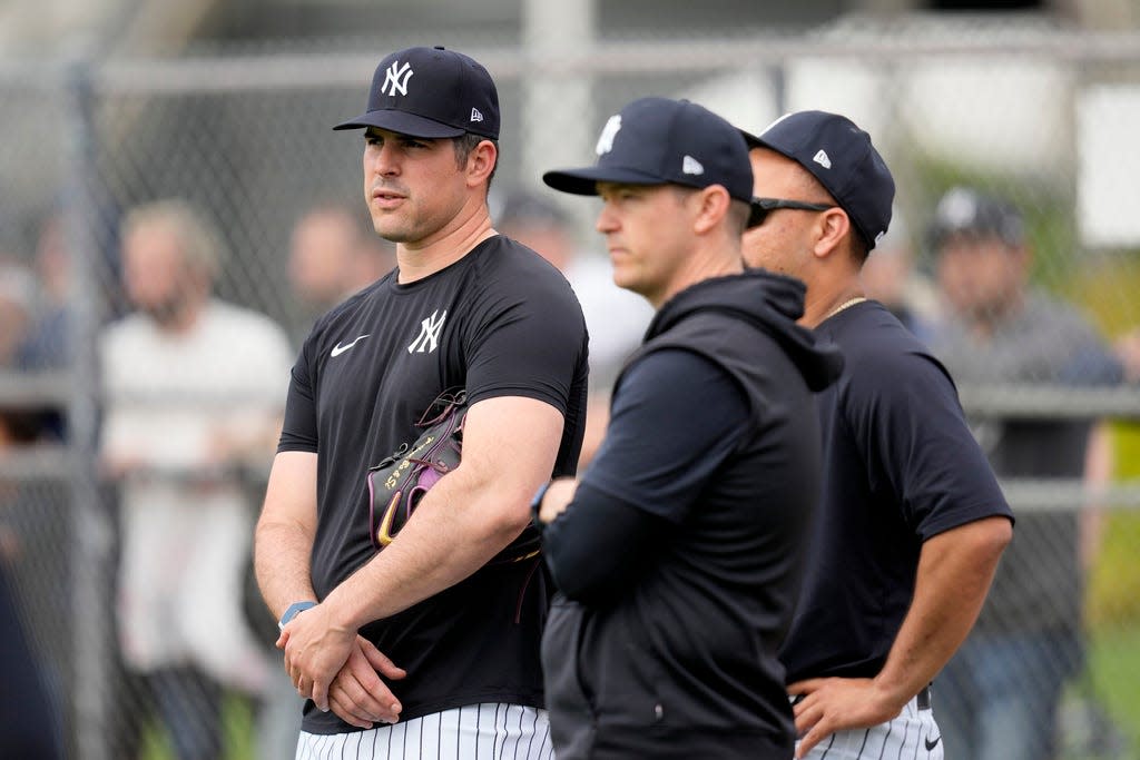 New York Yankees pitcher Carlos Rodon, left, watches a baseball spring training workout Thursday, Feb. 15, 2024, in Tampa, Fla.