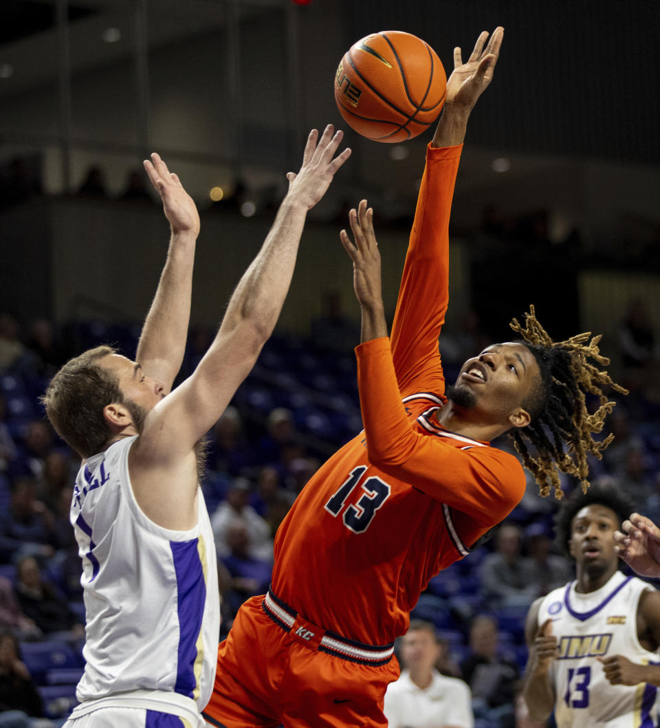 James Madison guard Noah Freidel (1) blocks a shot against Keystone forward DaShaun Johnson (13) during the first half of an NCAA college basketball game in Harrisonburg, Va., Sunday, Dec. 3, 2023. (Daniel Lin/Daily News-Record via AP)