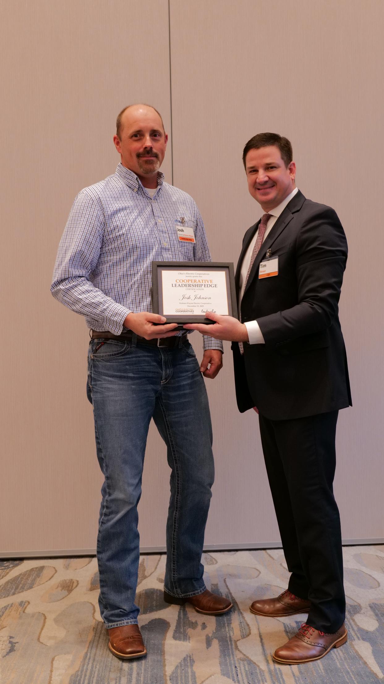 Josh Johnson (left) receives his Cooperative Leadership Edge program certificate from Tim Street.