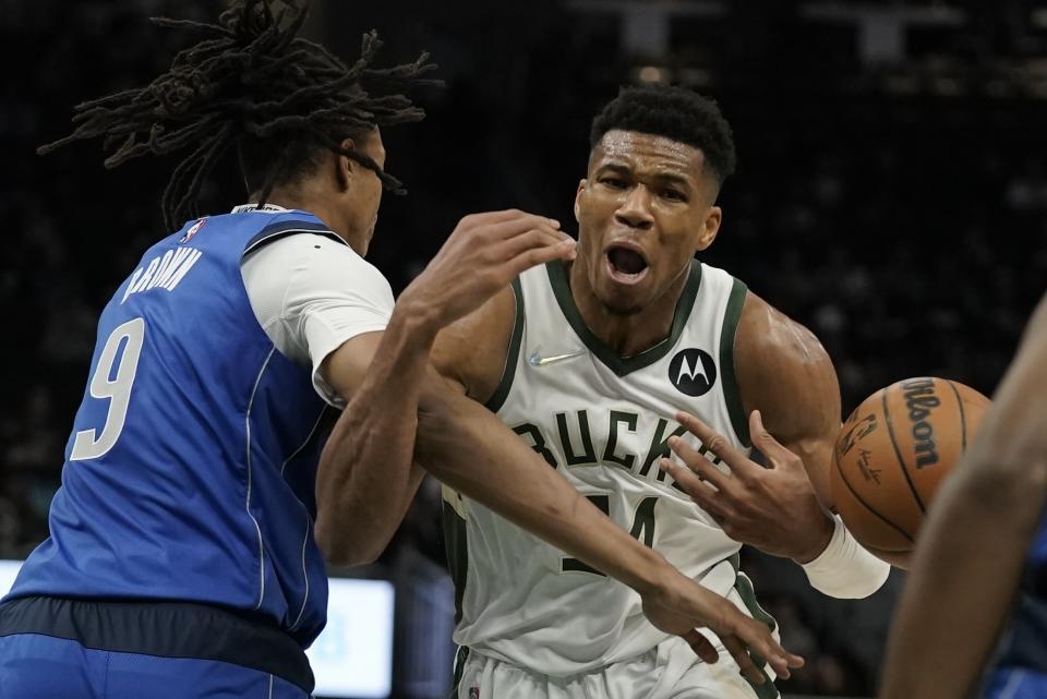 Dallas Mavericks' Moses Brown fouls Milwaukee Bucks' Giannis Antetokounmpo during the second half of an NBA preseason basketball game Friday, Oct. 15, 2021, in Milwaukee. (AP Photo/Morry Gash)