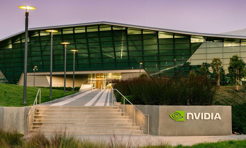 NVIDIA headquarters with gray NVIDIA logo in front and NVIDIA logo above.