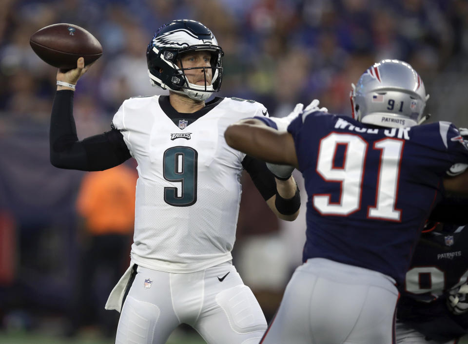 Philadelphia Eagles quarterback Nick Foles (9) passes under pressure from New England Patriots defensive end Deatrich Wise (91) during the first half of a preseason NFL football game Thursday, Aug. 16, 2018, in Foxborough, Mass. (AP Photo/Charles Krupa)