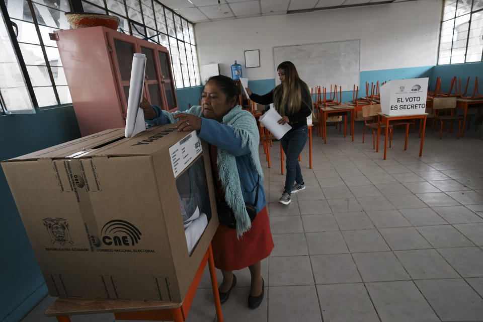 A voter casts her ballot in a snap presidential election in Cayambe, Ecuador, Sunday, Aug. 20, 2023. The special election was called after President Guillermo Lasso dissolved the National Assembly by decree in May to avoid being impeached. (AP Photo/Dolores Ochoa)