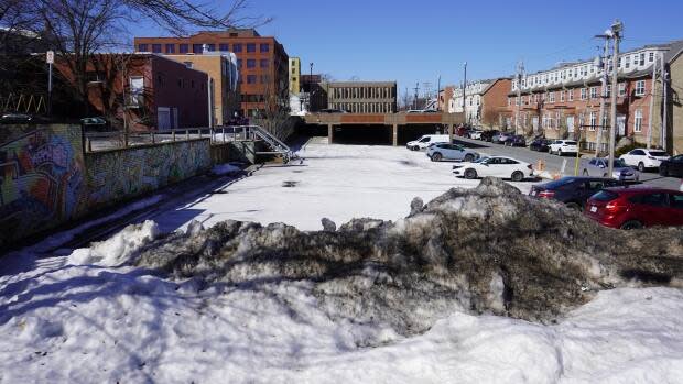 An investment of $1.5 million from Ottawa will help defray the land cost of this parking lot for the housing co-op, which will build two apartment buildings.  (Dave Laughlin/CBC - image credit)