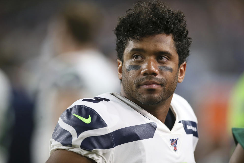 Seattle Seahawks quarterback Russell Wilson watches from the bench during the second half of an NFL preseason football game against the Minnesota Vikings, Sunday, Aug. 18, 2019, in Minneapolis. (AP Photo/Jim Mone)
