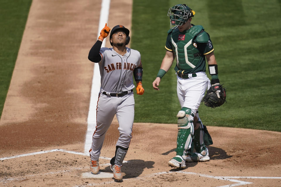 San Francisco Giants' Chadwick Tromp, left, celebrates after hitting a two-run home run next to Oakland Athletics catcher Sean Murphy during the third inning of a baseball game in Oakland, Calif., Sunday, Sept. 20, 2020. (AP Photo/Jeff Chiu)