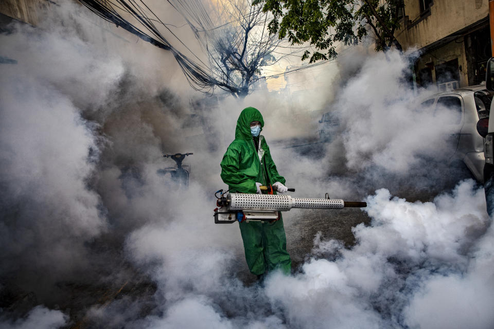 A worker wearing a hazmat suit uses a fogging machine to disinfect a street as preventive measure against COVID-19 on March 26, 2021 in Manila, Philippines. (Photo: Ezra Acayan/Getty Images)