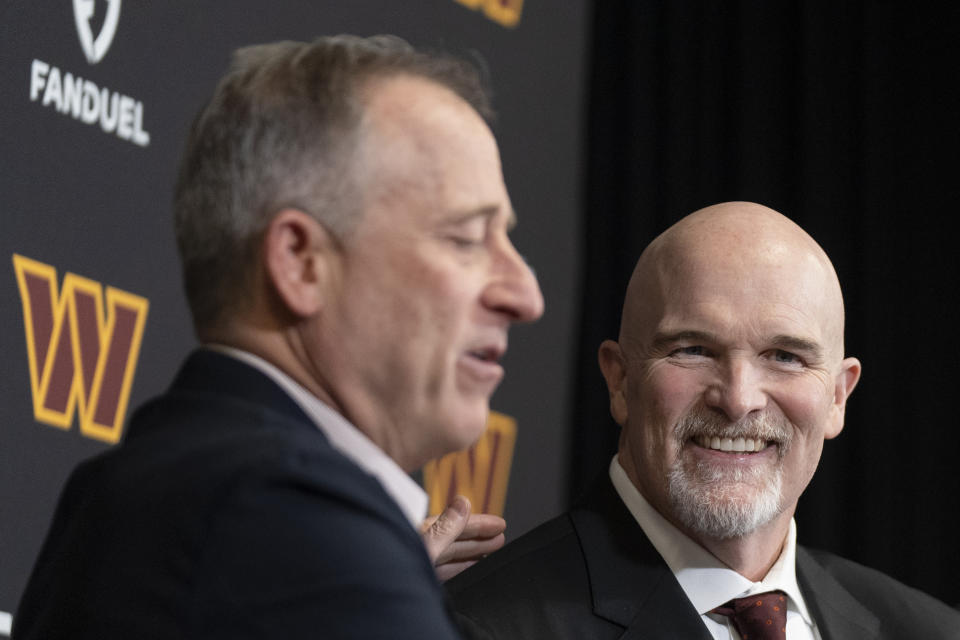 Washington Commanders new head coach Dan Quinn, right, reacts as he is introduced by Commanders managing partner Josh Harris, left, during an NFL football news conference at Commanders Park, in Ashburn, Va., Monday, Feb. 5, 2024. (AP Photo/Manuel Balce Ceneta)