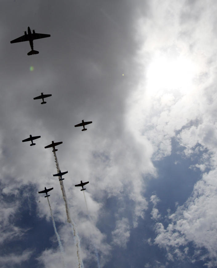 Vintage planes from the Cavanaugh Flight Museum fly over Globe Life Park before an opening day baseball game between the Texas Rangers and the Philadelphia Phillies, Monday, March 31, 2014, in Arlington, Texas. (AP Photo/Kim Johnson Flodin)