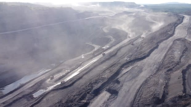 Dust from nine open pit coal mines often coats people and objects in Kiselyovsk, Russia. (Dmitry Kozlov/CBC - image credit)